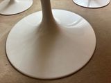 three white pedestals on the floor in a room