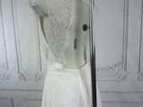the back of a wedding dress on a mannequin mannequin stand