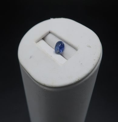 an image of a blue sapphire in a white container