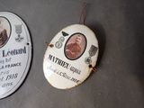 two plaques on the table with a picture of a man and a woman