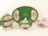 three pieces of green and pink china on the table