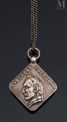 a close up of a necklace with a medallion on it