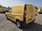 a yellow van that is parked in a parking lot