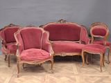 six chairs and a couch in a room