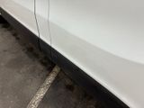 a white car parked in a parking lot next to a building