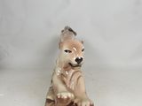 a small figurine of a dog sitting on a plate
