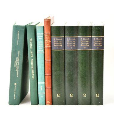 several books are stacked on top of each other on a white surface