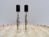 deux flacons de parfum posés sur un plateau en bois