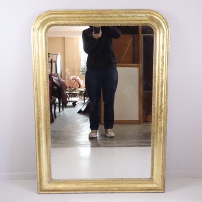a woman taking a picture of herself in a mirror