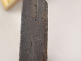 a wooden object with holes in the middle of it