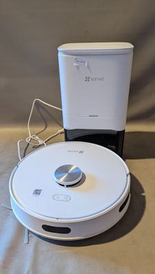 a robot that is sitting on a table next to a cup
