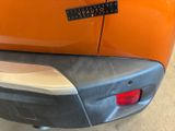 a close up of the rear end of an orange car