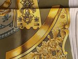 a picture of a scarf with a gold design on it