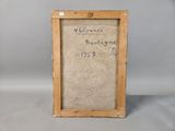 an old picture frame with writing on it sitting on a table