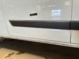 a close up of a white van with a sticker on it