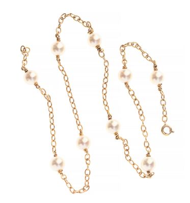 a gold chain with pearls on it