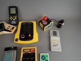 a table with a lot of electronic toys on it