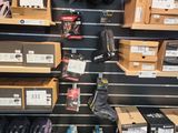 many pairs of shoes on the shelves in the store