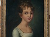 portrait of a young girl in a white dress in a gold frame