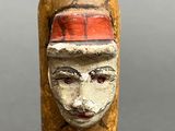 an old bottle with a face on it