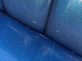 a close up of a blue couch with a blue seat