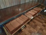 a long wooden table with a drawer on it