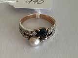 a close up of a ring on a white surface with a price tag