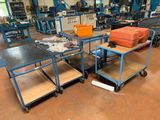 a room with many tables and carts in it