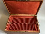 an old wooden box with silverware in it on a white surface