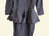 gray jacket and skirt on a hanger on a white background