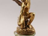 an image of a statue of a man with wings on a marble base