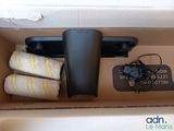 a box with a remote, a towel, and a cell phone in it