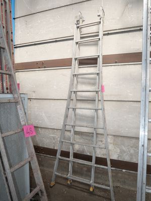 several ladders are lined up against a wall in a room