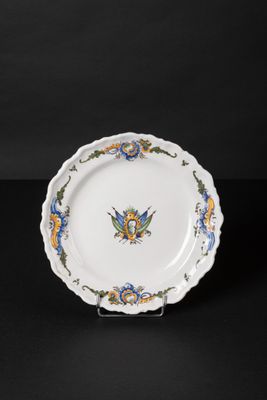 an image of a white plate with blue and yellow flowers on it