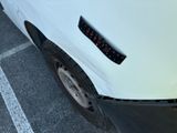 a close up of a white truck with a sticker on it ' s bumper