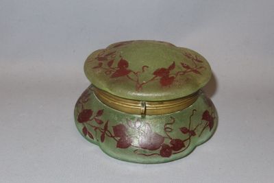 a small green box with red flowers on it