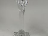 a glass vase with a flower on it on a table
