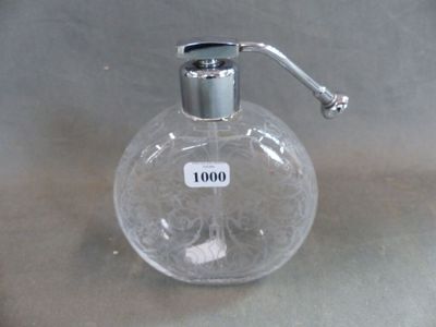 a clear glass bottle with a liquid dispenser on it