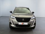 the front view of a silver car in a showroom