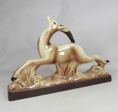 figurine of a running horse on a wooden base