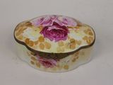a small white box with a pink rose on it