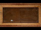 an old picture frame with a small piece of wood in it