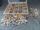 une boîte remplie de Lego de toutes sortes posée sur un lit