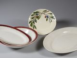 two plates and a bowl are sitting next to each other on a table