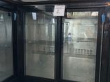 two glass doors that are open in a room