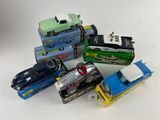 several toy cars are stacked on top of each other on a white surface