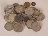 a pile of coins sitting on a table with a white background