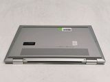 a laptop that is sitting on a white surface