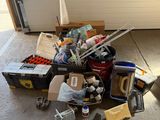 a pile of junk in a garage next to a garage door