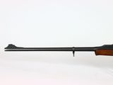 a rifle with a wooden barrel on a white background